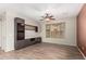 Open-concept living room featuring tile floors, custom built-ins, and a ceiling fan at 21059 E Pickett St, Queen Creek, AZ 85142