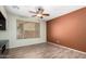 Bright, flexible living room featuring wood-look floors, bright windows, and a ceiling fan at 21059 E Pickett St, Queen Creek, AZ 85142
