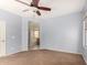 Spacious bedroom with neutral carpet, ceiling fan, and en-suite bathroom at 21059 E Pickett St, Queen Creek, AZ 85142