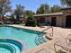 Community pool featuring a hot tub, shaded seating area, and ample space to relax and enjoy the outdoors at 21059 E Pickett St, Queen Creek, AZ 85142