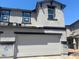 New construction home featuring a gray stucco finish, black trim, a two-car garage, and an asymmetrical roof line at 21244 N 58Th St, Phoenix, AZ 85054