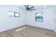 Bright bedroom featuring hardwood floors, a modern ceiling fan, and two windows at 214 W Ruth Ave, Phoenix, AZ 85021