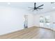 Spacious bedroom featuring hardwood floors, a modern ceiling fan, and a door to the backyard at 214 W Ruth Ave, Phoenix, AZ 85021