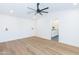 Spacious bedroom featuring hardwood floors, a modern ceiling fan, and gold sconce lighting at 214 W Ruth Ave, Phoenix, AZ 85021