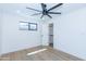 Bright bedroom featuring hardwood floors, a modern ceiling fan, and a walk-in closet at 214 W Ruth Ave, Phoenix, AZ 85021