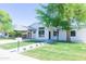 Beautifully renovated home with a well-manicured lawn, modern white paint, and stylish black accents at 214 W Ruth Ave, Phoenix, AZ 85021