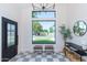 Bright and spacious foyer with stylish checkered floors, modern lighting, and a large window offering outdoor views at 214 W Ruth Ave, Phoenix, AZ 85021