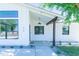 Inviting front porch with contemporary design elements, including a stylish black door frame and sleek lighting at 214 W Ruth Ave, Phoenix, AZ 85021