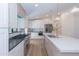 Spacious kitchen featuring stainless steel appliances, long island with sink, and white custom cabinetry at 214 W Ruth Ave, Phoenix, AZ 85021
