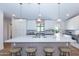 Bright, modern kitchen with large island, pendant lighting, stainless steel appliances, and breakfast bar at 214 W Ruth Ave, Phoenix, AZ 85021