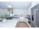 Beautiful kitchen boasts stainless steel refrigerator, marble island, black countertops, and backyard access at 214 W Ruth Ave, Phoenix, AZ 85021