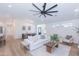 Bright and airy living space with wood floors, a large ceiling fan, and a seamless flow into the dining area at 214 W Ruth Ave, Phoenix, AZ 85021