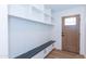 Mudroom features built-in shelving, bench with storage, and a stylish wood door at 214 W Ruth Ave, Phoenix, AZ 85021