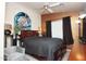 Bright bedroom with a king bed, a ceiling fan and a creative, colorful piece of artwork above the headboard at 2150 W Alameda Rd # 2037, Phoenix, AZ 85085