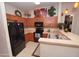 Well-lit kitchen with light countertops, wood cabinets, and black appliances at 2150 W Alameda Rd # 2037, Phoenix, AZ 85085