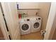 Convenient laundry room with a modern washer and dryer, plus overhead shelving for extra storage space at 2150 W Alameda Rd # 2037, Phoenix, AZ 85085