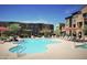 Resort style pool featuring lounge chairs and umbrellas with well maintained landscaping surrounding the area at 2150 W Alameda Rd # 2037, Phoenix, AZ 85085