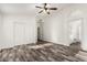 Spacious bedroom featuring wood-look floors, closet, and ensuite bathroom at 2223 E Crest Ln, Phoenix, AZ 85024