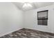 This bedroom features new laminate flooring, white trim, and a double hung window at 2223 E Crest Ln, Phoenix, AZ 85024