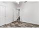 This bedroom features a doorway leading into the bathroom, modern flooring, and ample lighting at 2223 E Crest Ln, Phoenix, AZ 85024