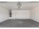 Spacious two car garage with painted walls and concrete floor at 2223 E Crest Ln, Phoenix, AZ 85024