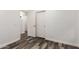 Bright hallway leads to bedrooms with laminate flooring and multiple doors at 2223 E Crest Ln, Phoenix, AZ 85024