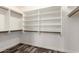 This walk-in closet features custom shelving and clothing racks with laminate flooring at 2223 E Crest Ln, Phoenix, AZ 85024