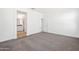 Spacious bedroom with neutral carpet, offering ample room to personalize and an en suite bathroom at 22530 N Lynn St, Maricopa, AZ 85138