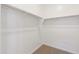 Walk-in closet with carpet and ample hanging space, offering generous storage in the home at 22530 N Lynn St, Maricopa, AZ 85138