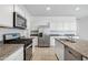 Modern kitchen showcasing stainless steel appliances, granite countertops, and white cabinetry at 22530 N Lynn St, Maricopa, AZ 85138
