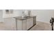 Granite kitchen island features a sink, dishwasher, and white cabinets at 22530 N Lynn St, Maricopa, AZ 85138
