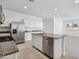 Stylish kitchen featuring stainless steel appliances, island with sink, and sleek countertops at 22530 N Lynn St, Maricopa, AZ 85138