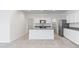 Open concept kitchen with island, modern appliances, and ample cabinet space at 22530 N Lynn St, Maricopa, AZ 85138