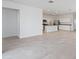 Open-concept living area with tile flooring seamlessly connects to the kitchen at 22530 N Lynn St, Maricopa, AZ 85138
