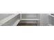 Walk-in pantry featuring white shelving and tile flooring at 22530 N Lynn St, Maricopa, AZ 85138