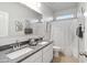 Bright bathroom with double sinks, granite countertops, a large mirror, and a shower-tub combination at 22570 N Lynn St, Maricopa, AZ 85138