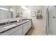 Bright bathroom featuring a double vanity, granite countertops, framed botanical prints, and a shower with a curtain at 22570 N Lynn St, Maricopa, AZ 85138