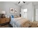 Bedroom features neutral walls, comfy bedding, natural lighting, and a walk-in closet with a door at 22570 N Lynn St, Maricopa, AZ 85138