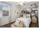 This bedroom is decorated with mountain theme wallpaper on the wall behind the bed and natural lighting at 22570 N Lynn St, Maricopa, AZ 85138