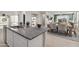 Kitchen with granite countertops, stainless steel sink, white cabinetry, and open to the living spaces at 22570 N Lynn St, Maricopa, AZ 85138