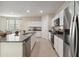 Well-lit kitchen with stainless steel appliances, a granite island, and an open layout to the dining area at 22570 N Lynn St, Maricopa, AZ 85138