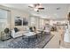 Bright, open-concept living area with comfortable seating, a ceiling fan, and views of the kitchen at 22570 N Lynn St, Maricopa, AZ 85138