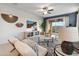 Cozy living room with a TV, ceiling fan, stylish furniture, and sliding glass door to the backyard at 22570 N Lynn St, Maricopa, AZ 85138