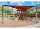 Neighborhood playground featuring a slide, climbing structures, and shaded seating areas at 22570 N Lynn St, Maricopa, AZ 85138