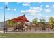 Community playground with slides and covered play area for hours of entertainment on a sunny day at 22570 N Lynn St, Maricopa, AZ 85138