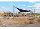 A shaded playground area with swings and play equipment invites families to gather and enjoy the outdoors at 22570 N Lynn St, Maricopa, AZ 85138