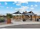Exterior view of Red River Park with playground, picnic area, and clear blue sky at 22570 N Lynn St, Maricopa, AZ 85138