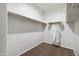 A practical walk-in closet offers ample storage space with shelving and hanging rods for organization at 22570 N Lynn St, Maricopa, AZ 85138