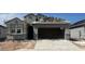 New construction home featuring stucco exterior, open garage and a roof in progress under a beautiful sunny sky at 22610 N Lynn St, Maricopa, AZ 85138