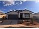 Charming single-story home featuring a gray color scheme, a two-car garage, and drought-resistant landscaping at 22610 N Lynn St, Maricopa, AZ 85138
